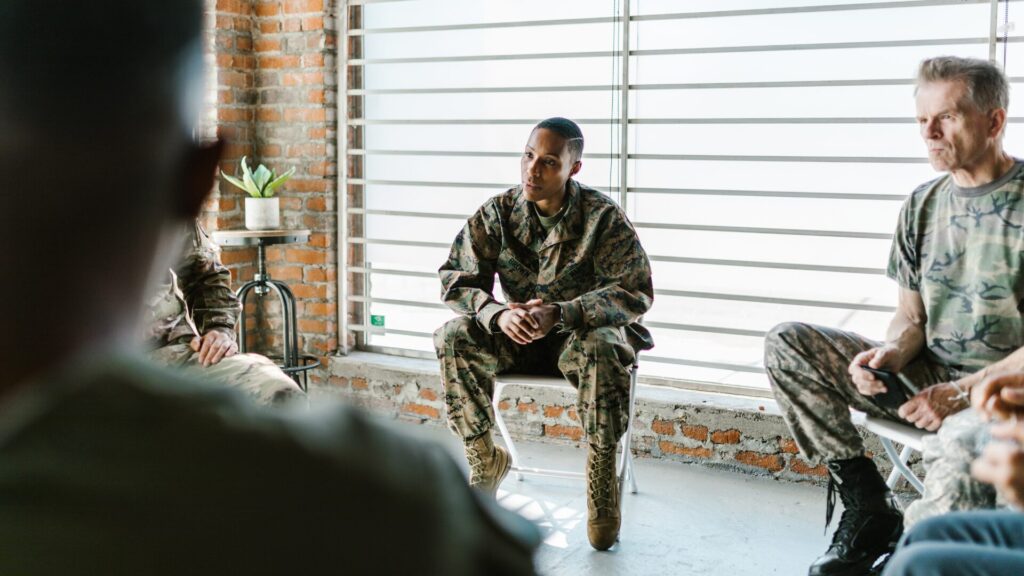 Veterans participating in a classroom setting, engaged in discussion and learning as part of an educational program designed to empower them and their families.